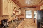 Eagle`s Lair kitchen with tongue and  grove wood ceilings.